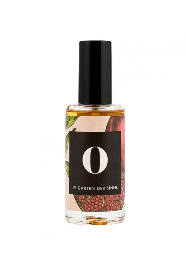 Parfümflasche mit botanischem Etikett &quot;Im Garten der Sinne&quot;.