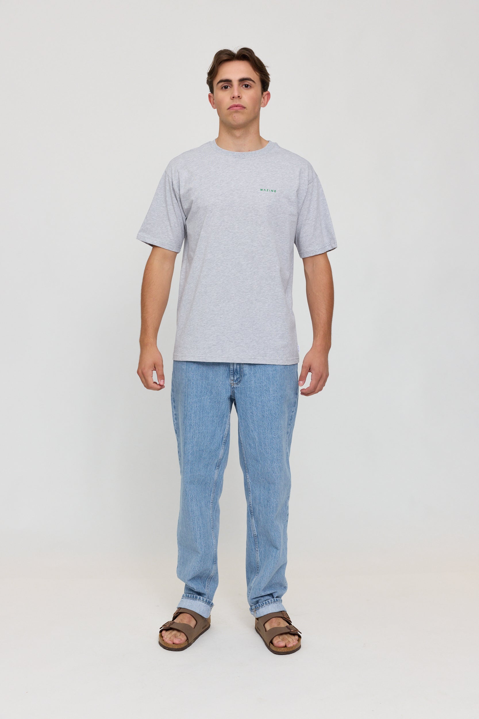Junger Mann in grauem T-Shirt und Jeans
