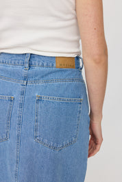Person trägt Jeans mit Markenlabel 'MAZINE'