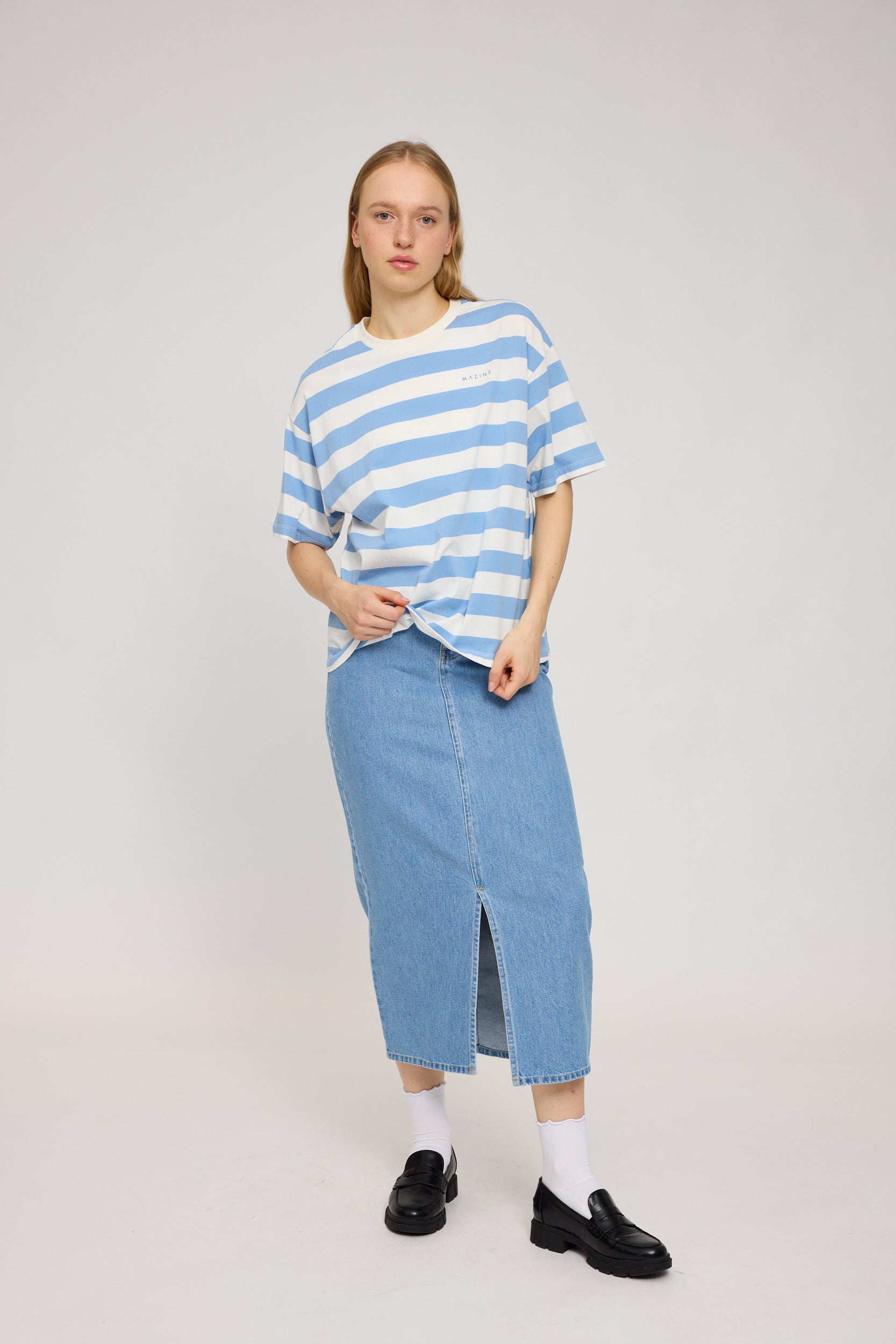 Frau in blauem Streifen-T-Shirt und Jeansrock