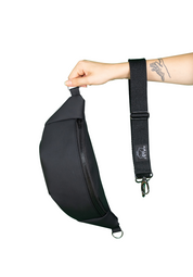 Hand hält modische schwarze Bauchtasche