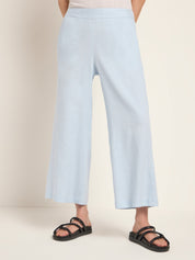 Frau in hellblauen Culottes und schwarzen Sandalen