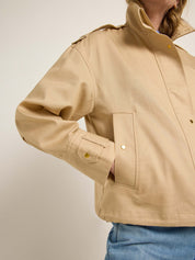 Detailaufnahme einer beige Jacke mit Jeans