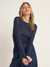 Frau in blauem Oberteil und gestreifter Hose