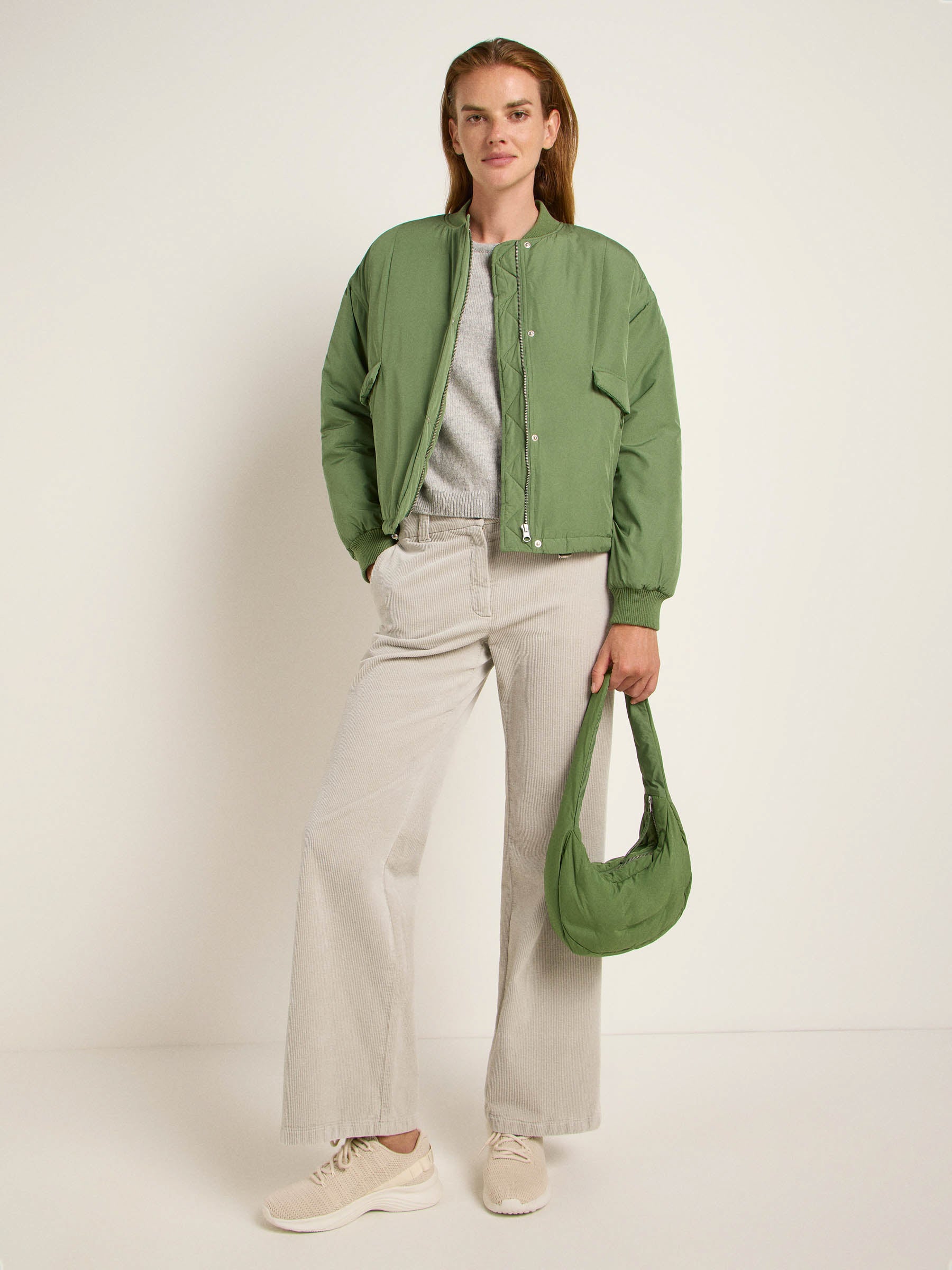 Mann in grüner Jacke und beigen Hosen