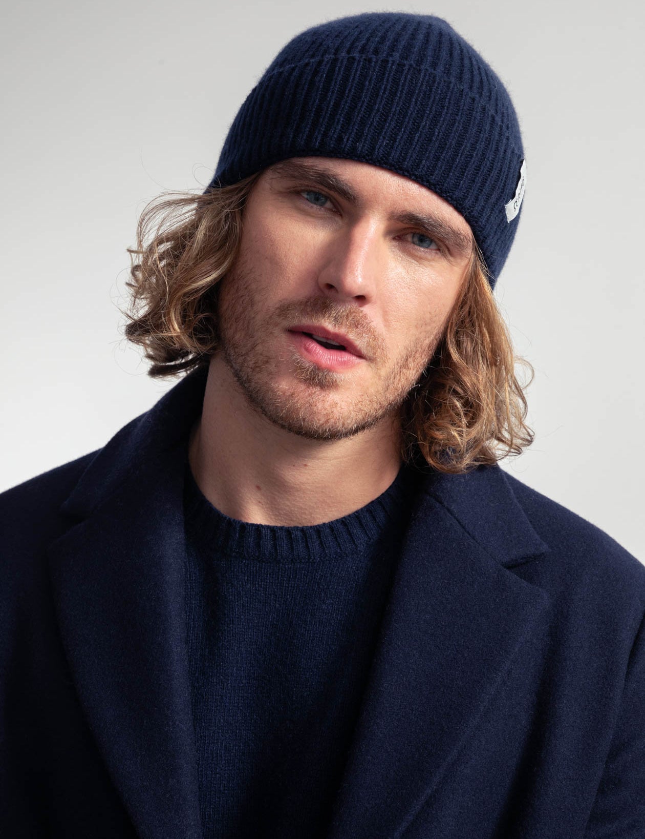 Mann mit Mütze und stilvollem Mantel