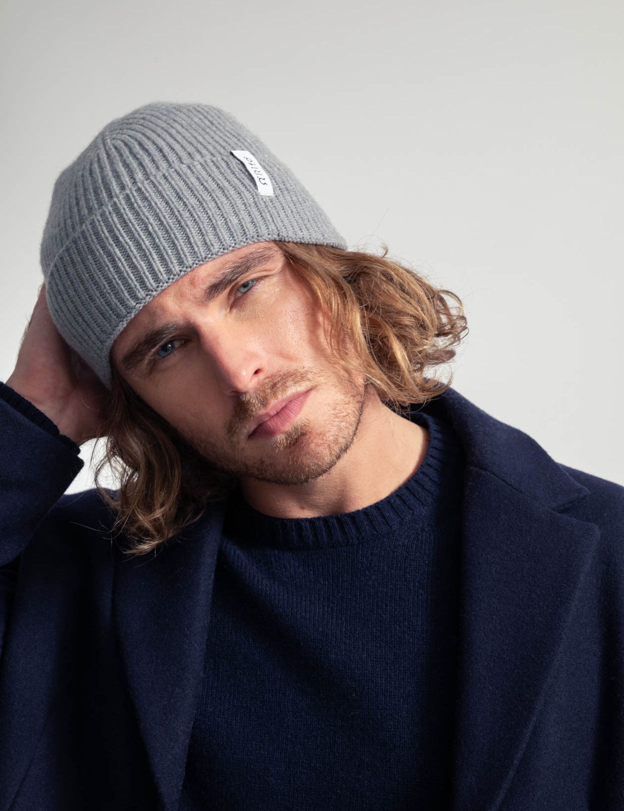 Mann mit Mütze und dunkelblauem Mantel