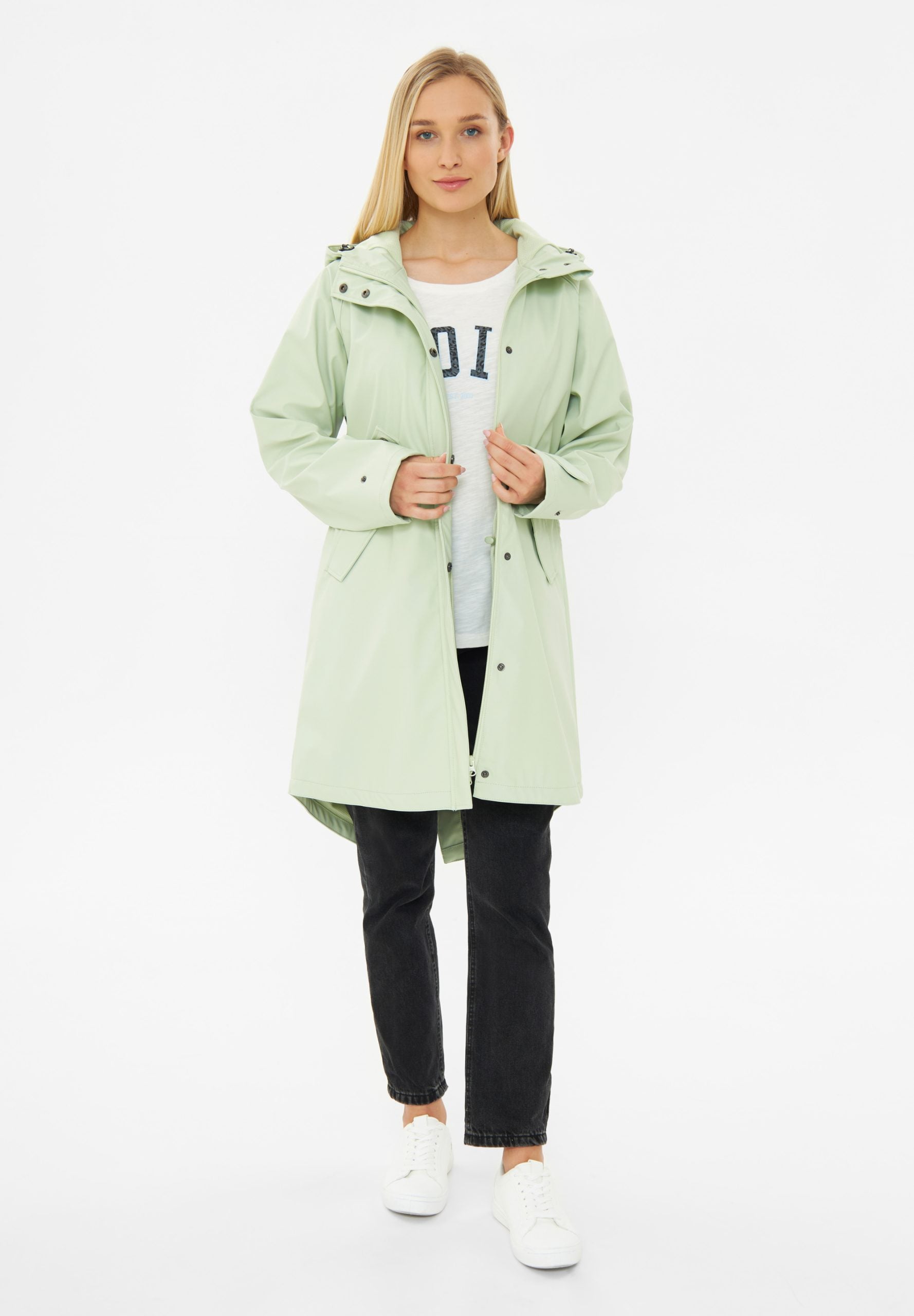 Frau in grüner Jacke und schwarzen Jeans