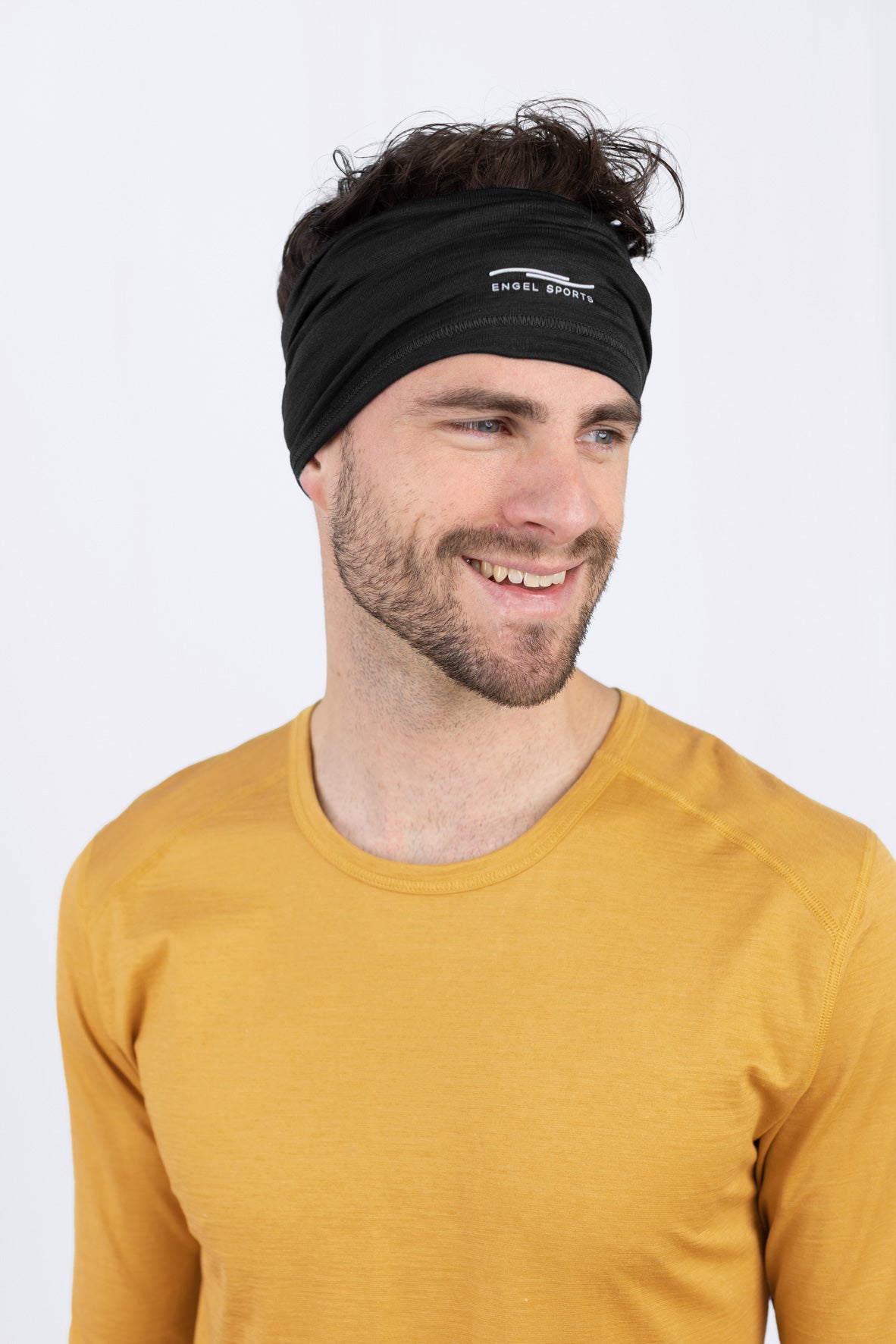 Lächelnder Mann im gelben Shirt und Stirnband